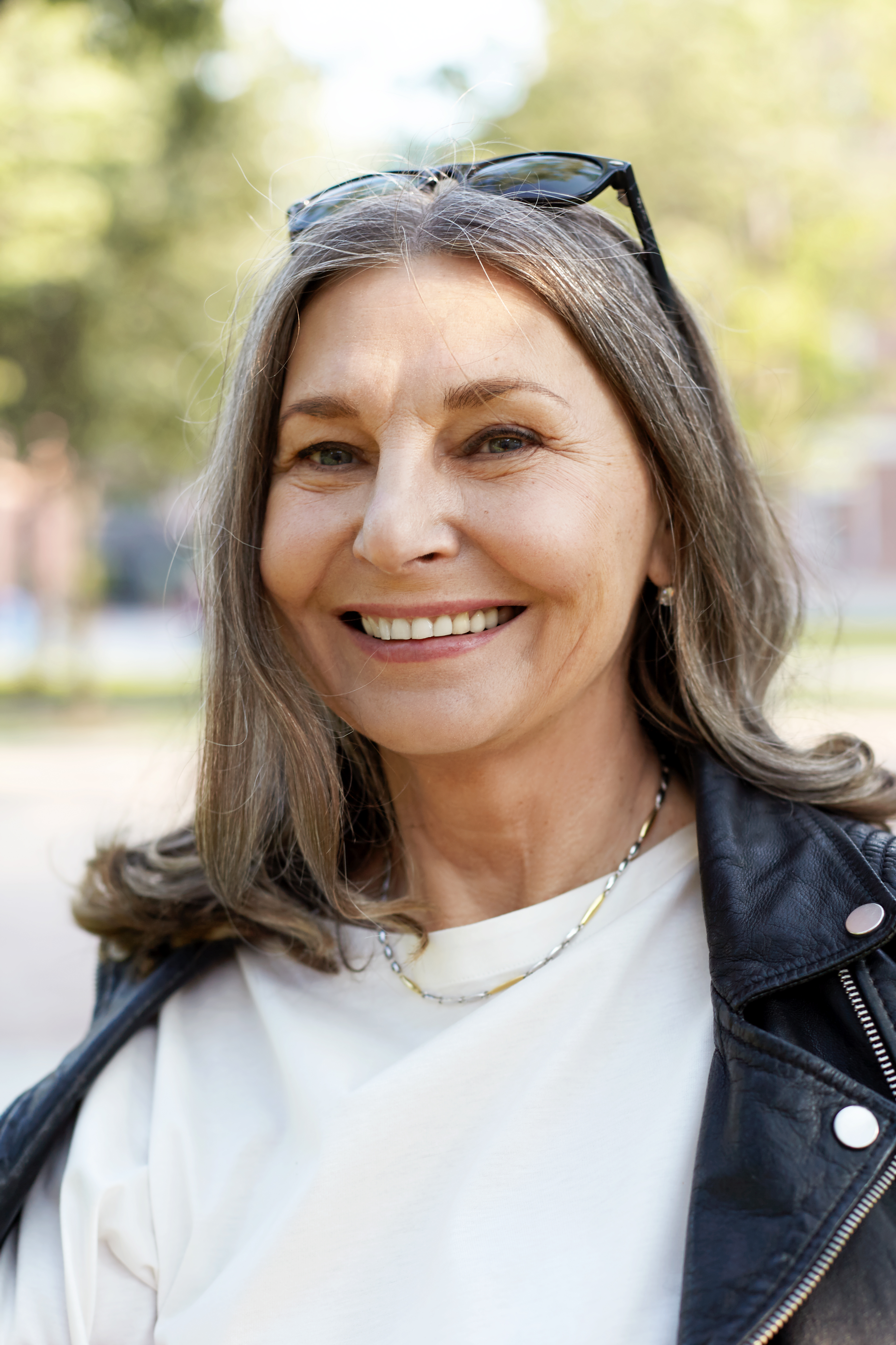 Woman smiling with confidence after improving her oral health